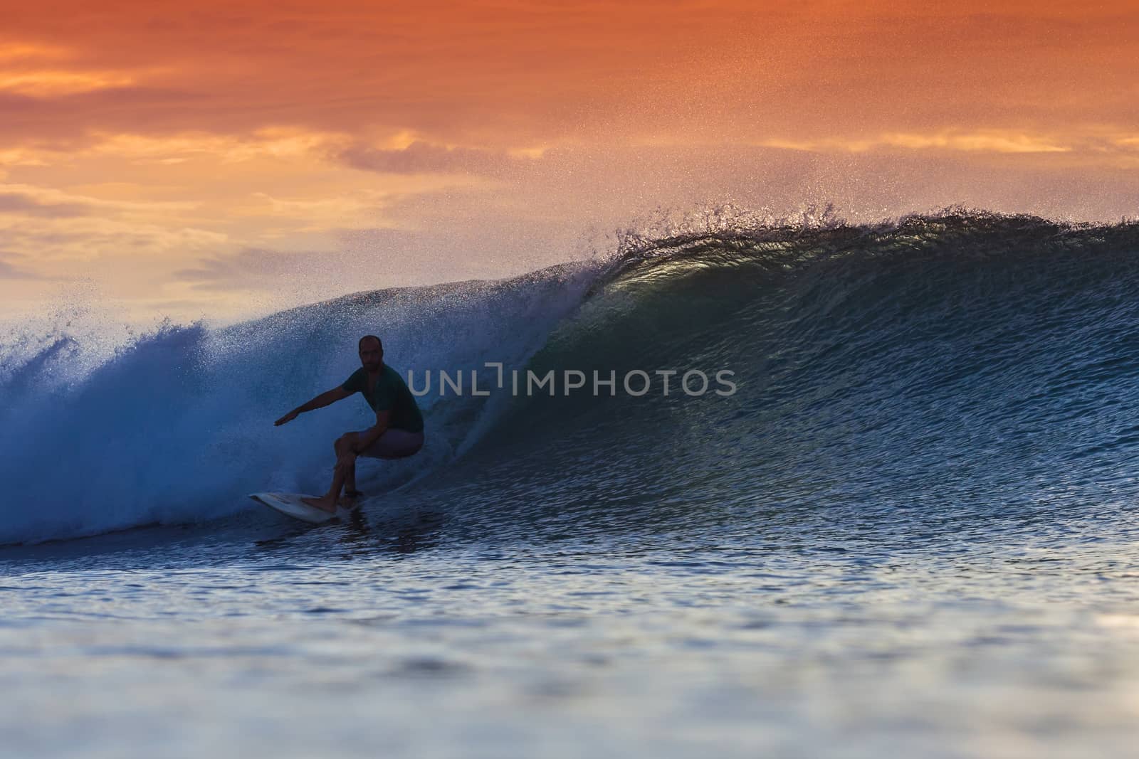 Surfer on Amazing Wave at sunset time, Bali island.