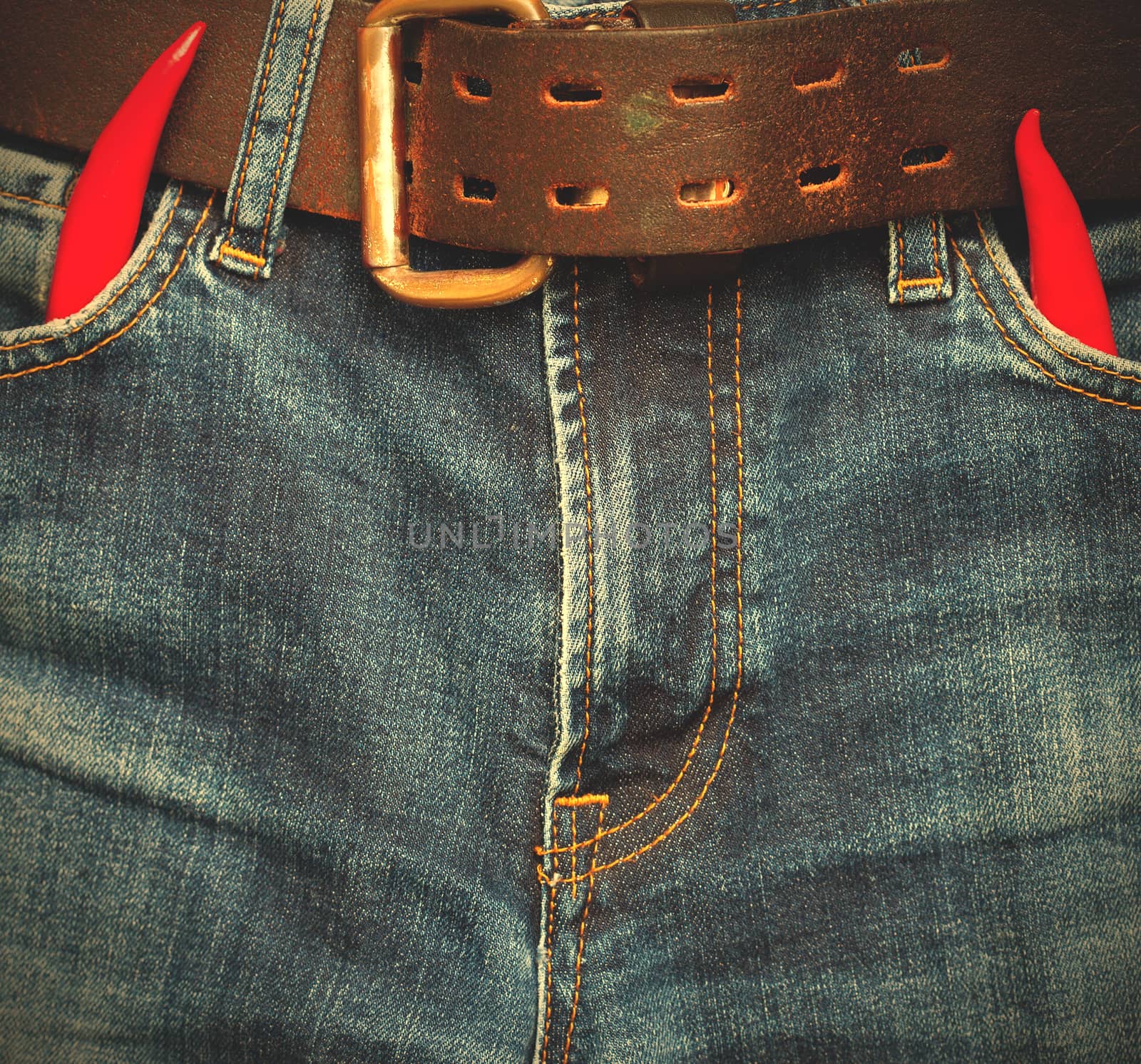old blue jeans with red chili pepper in the pockets. instagram image style