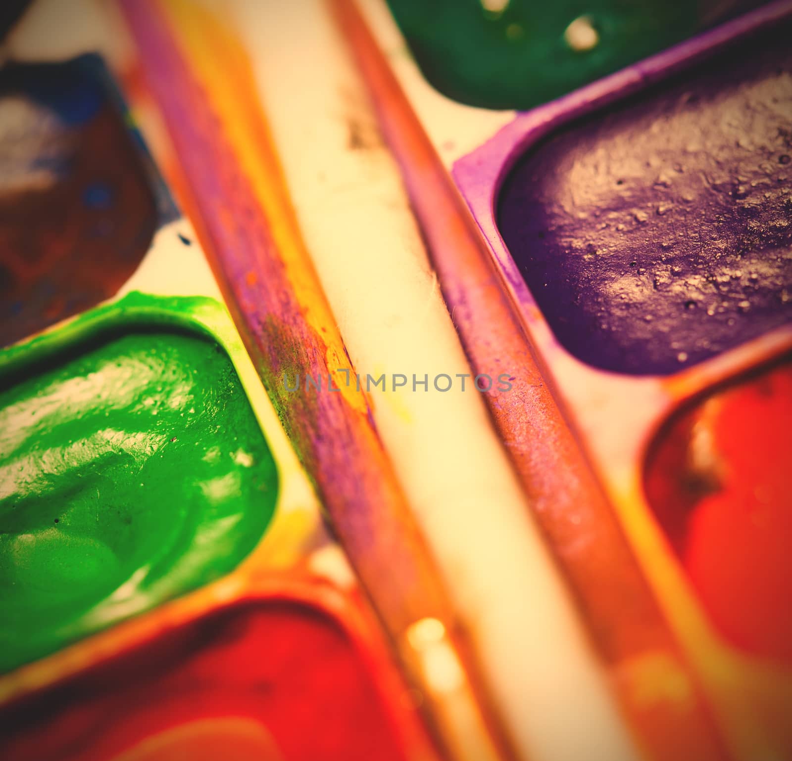 set of watercolor paints, shallow depth of field. instagram image retro style