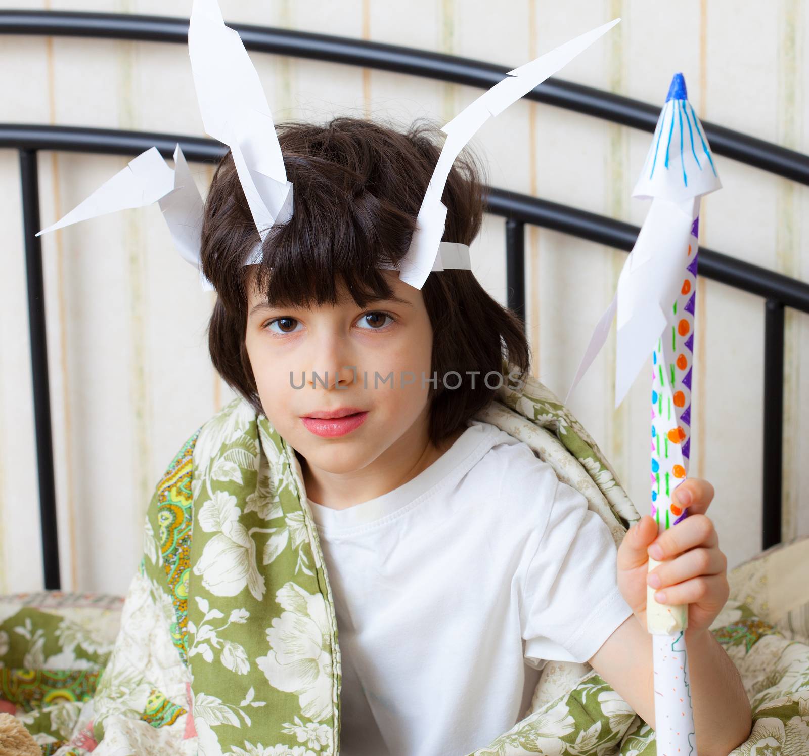 funny boy in the image of the American Indian with a spear in his hand