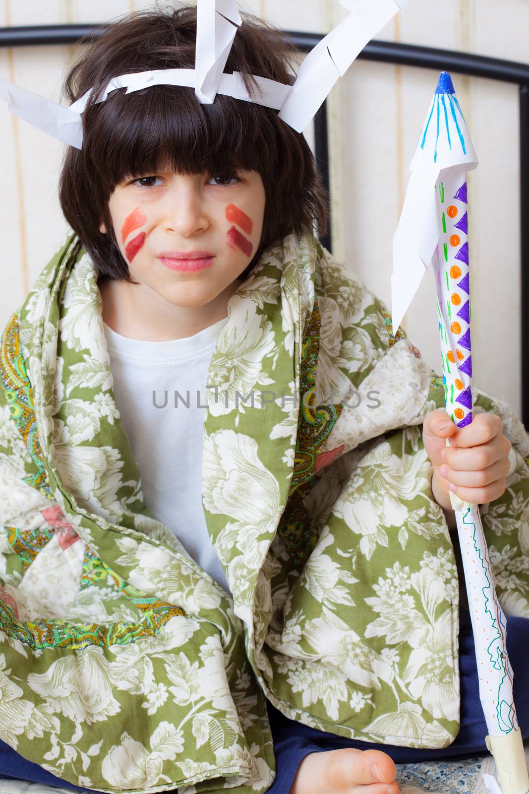 boy playing with a spear in his hand in the image of the American Indian