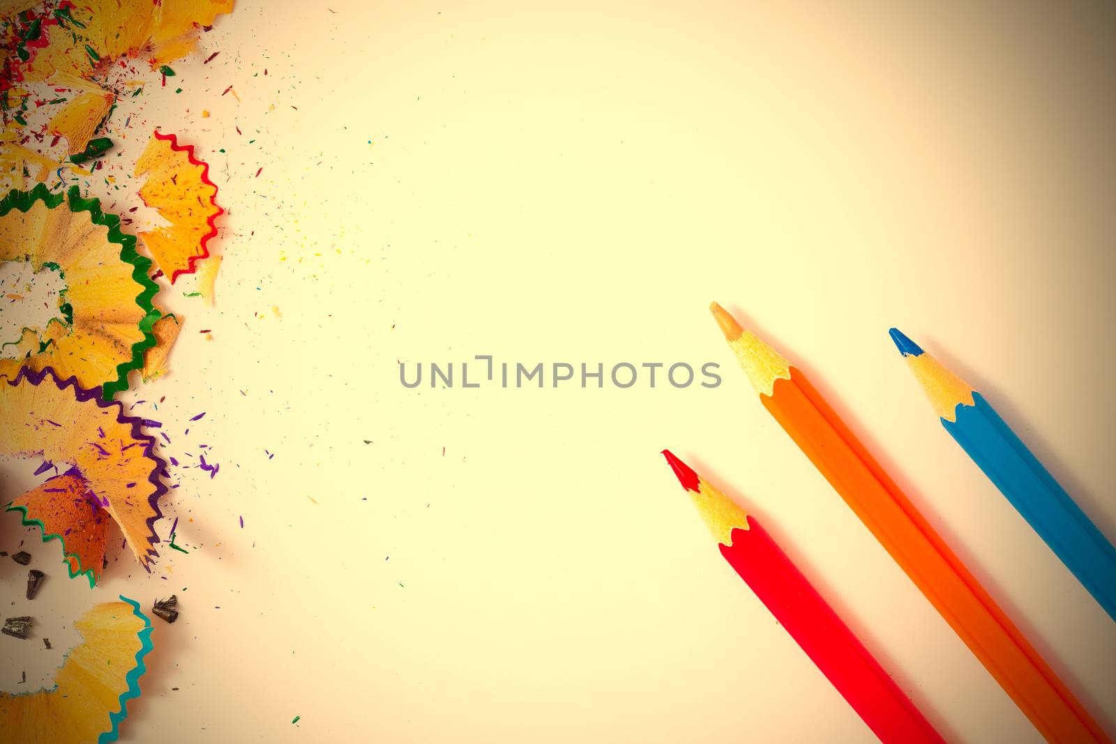 variolored pencil and shavings on a white background. instagram image retro style