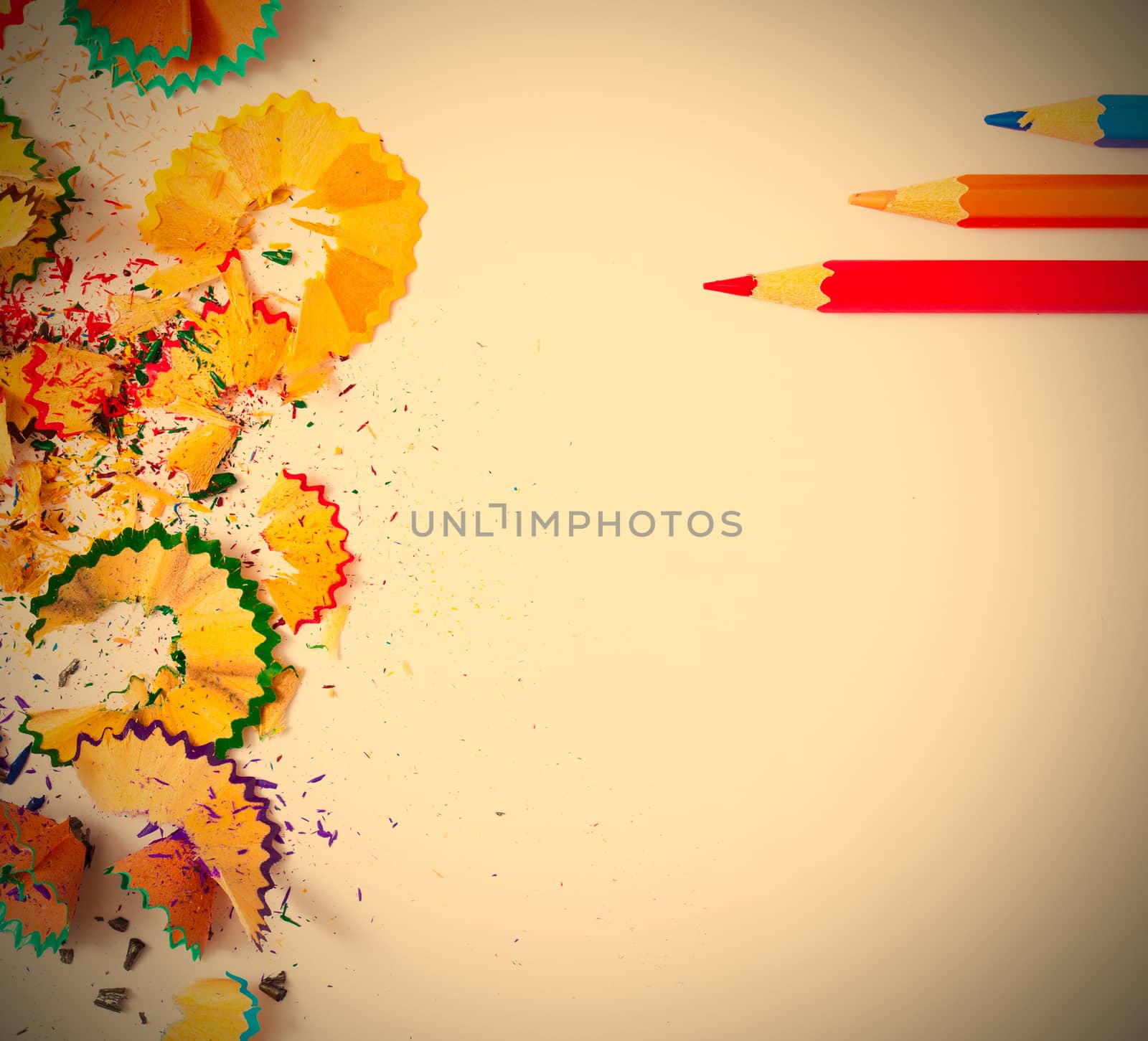 colored pencils and shavings on white background with copy space. instagram image retro style