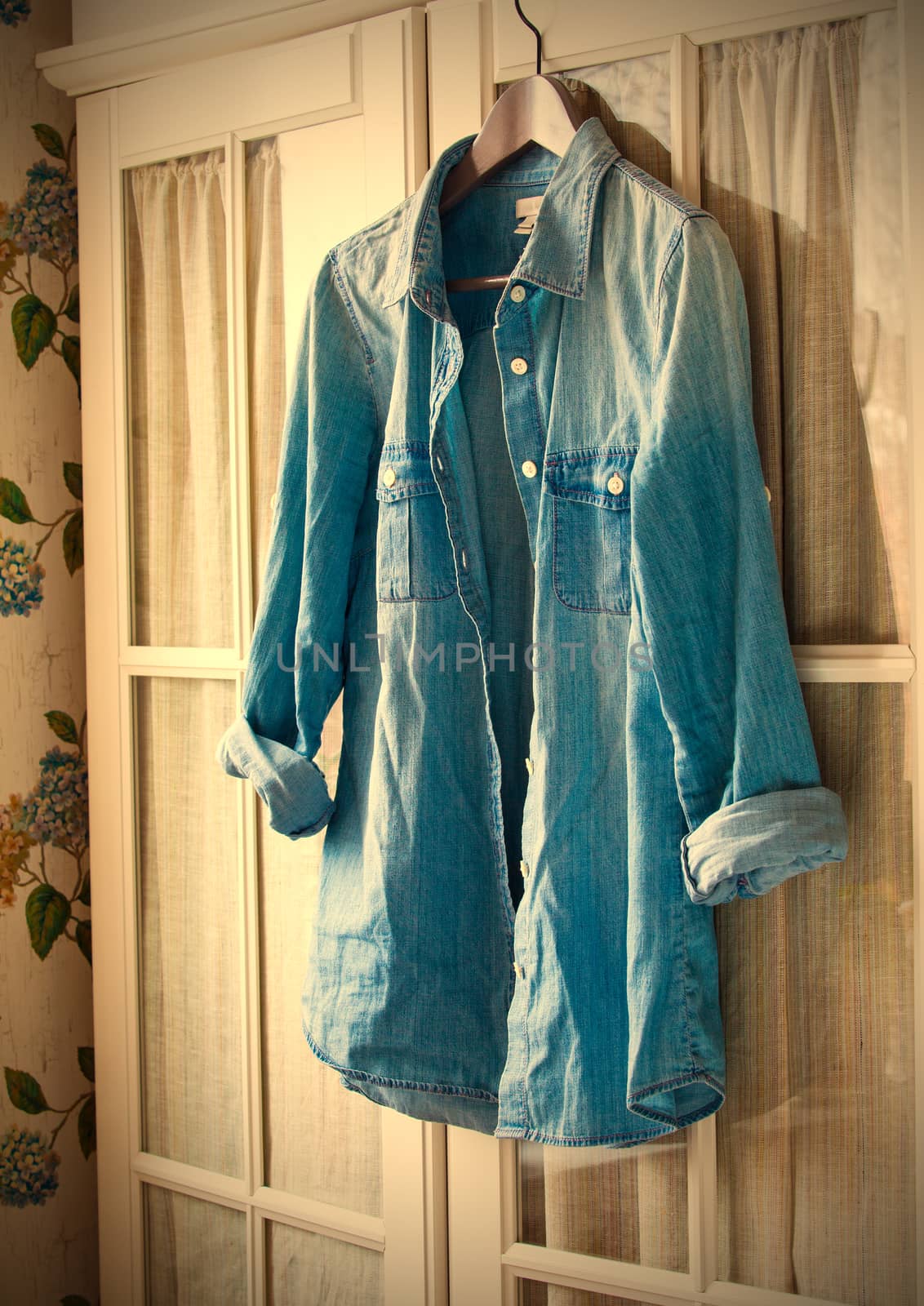 denim shirt on a hanger on the door wardrobes. instagram image style