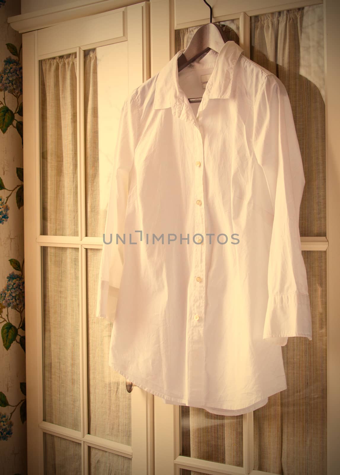 white cotton shirt on a hanger on the door wardrobes. instagram, image style