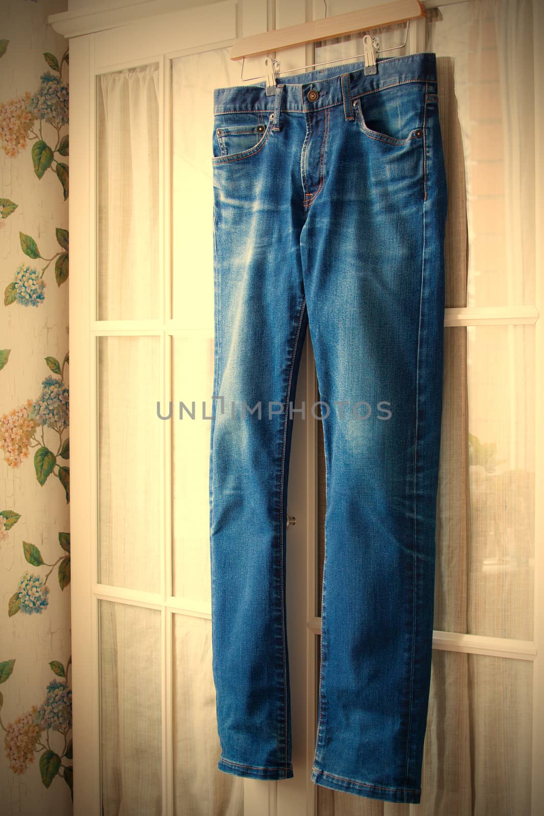 jeans on hangers on the door wardrobes. instagram image retro style