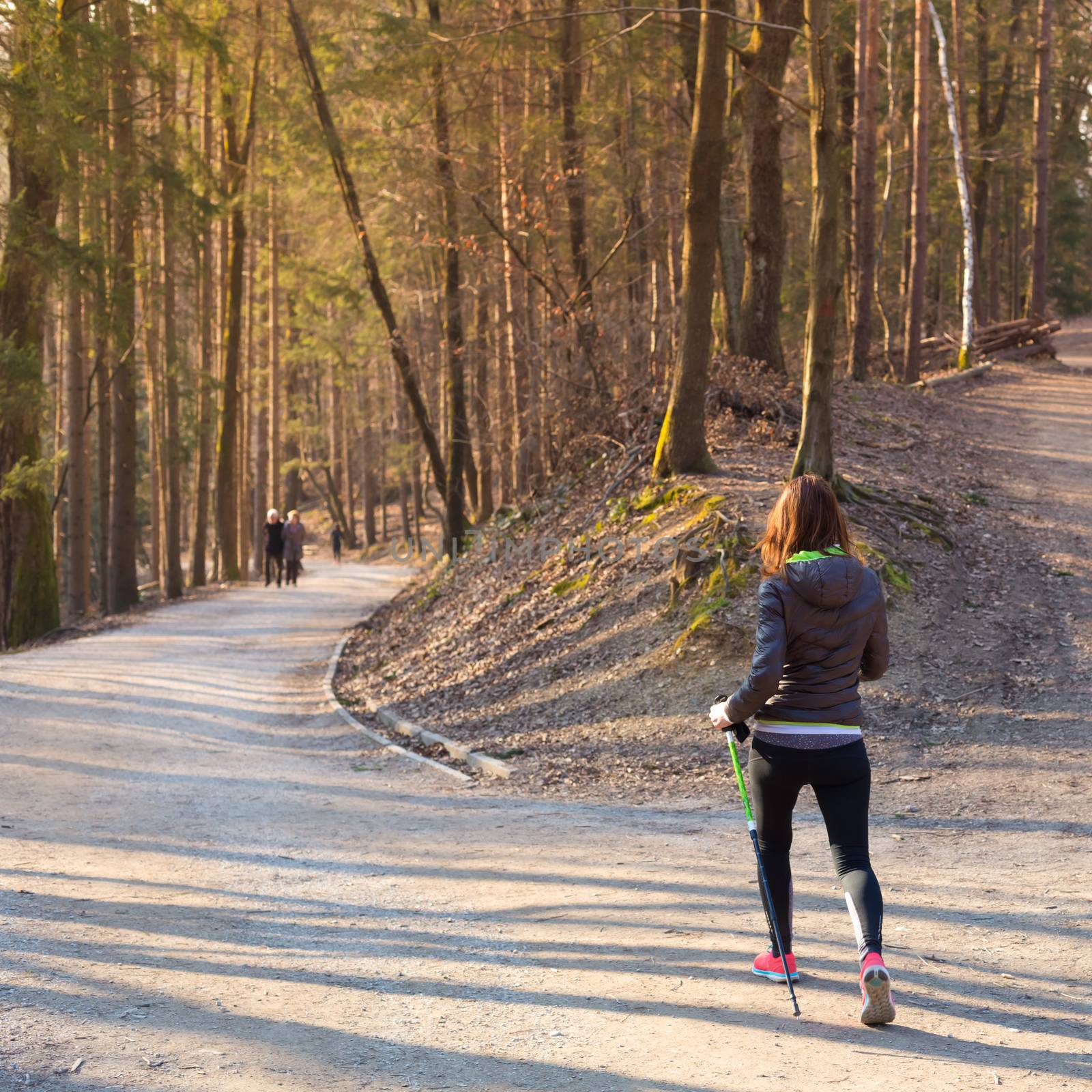 Young fit woman hiking in nature. Adventure, sport and exercise. 