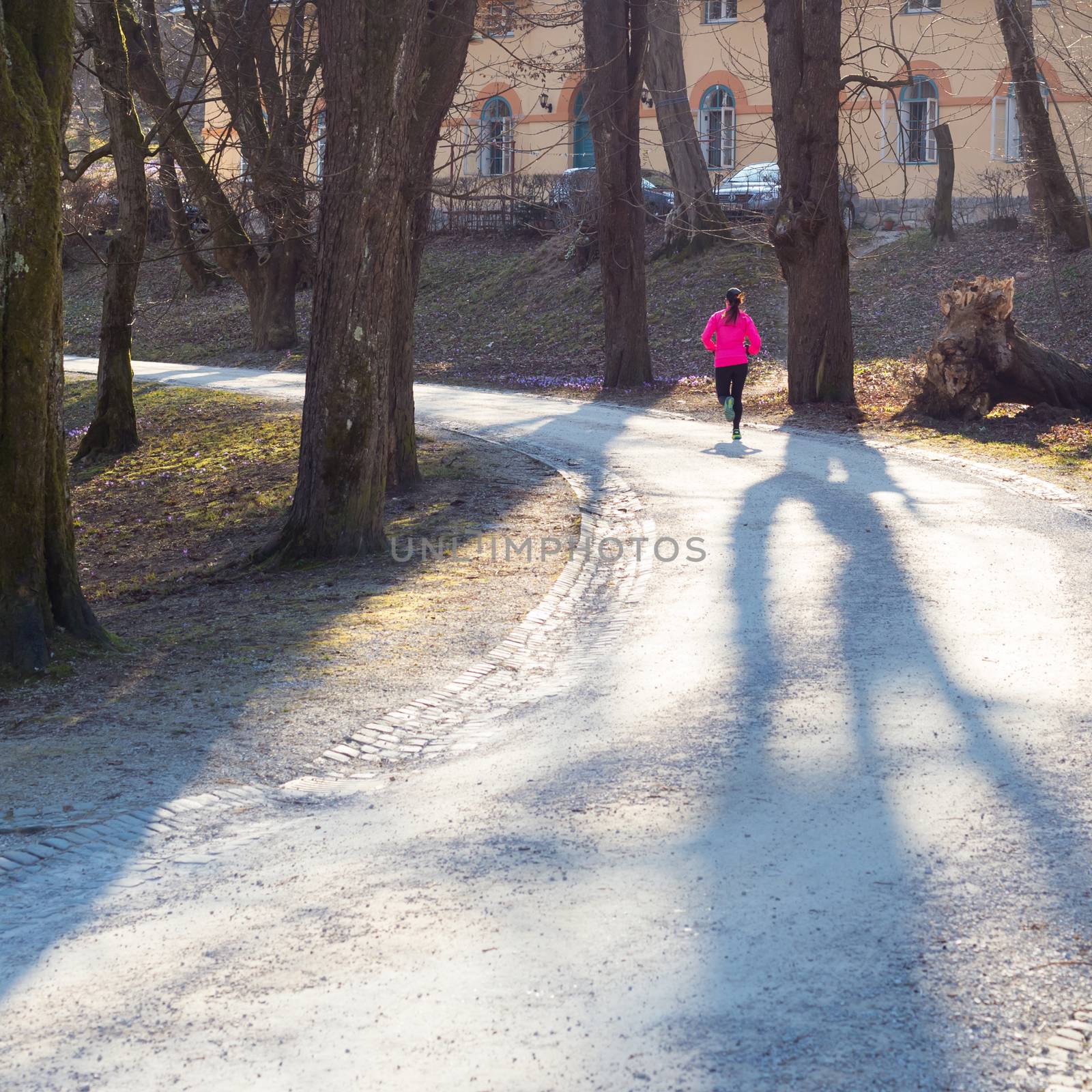 Lady running in the forest.  Running woman. Female runner jogging during outdoor workout in a Nature. Fitness model outdoors. Weight Loss. Healthy lifestyle. 