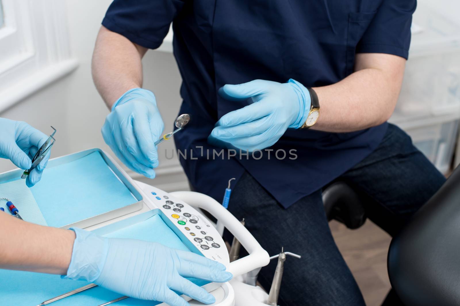 Cropped image of male dentist with tools by stockyimages