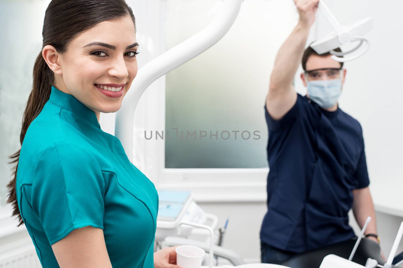 Dental assistants in dental clinic by stockyimages