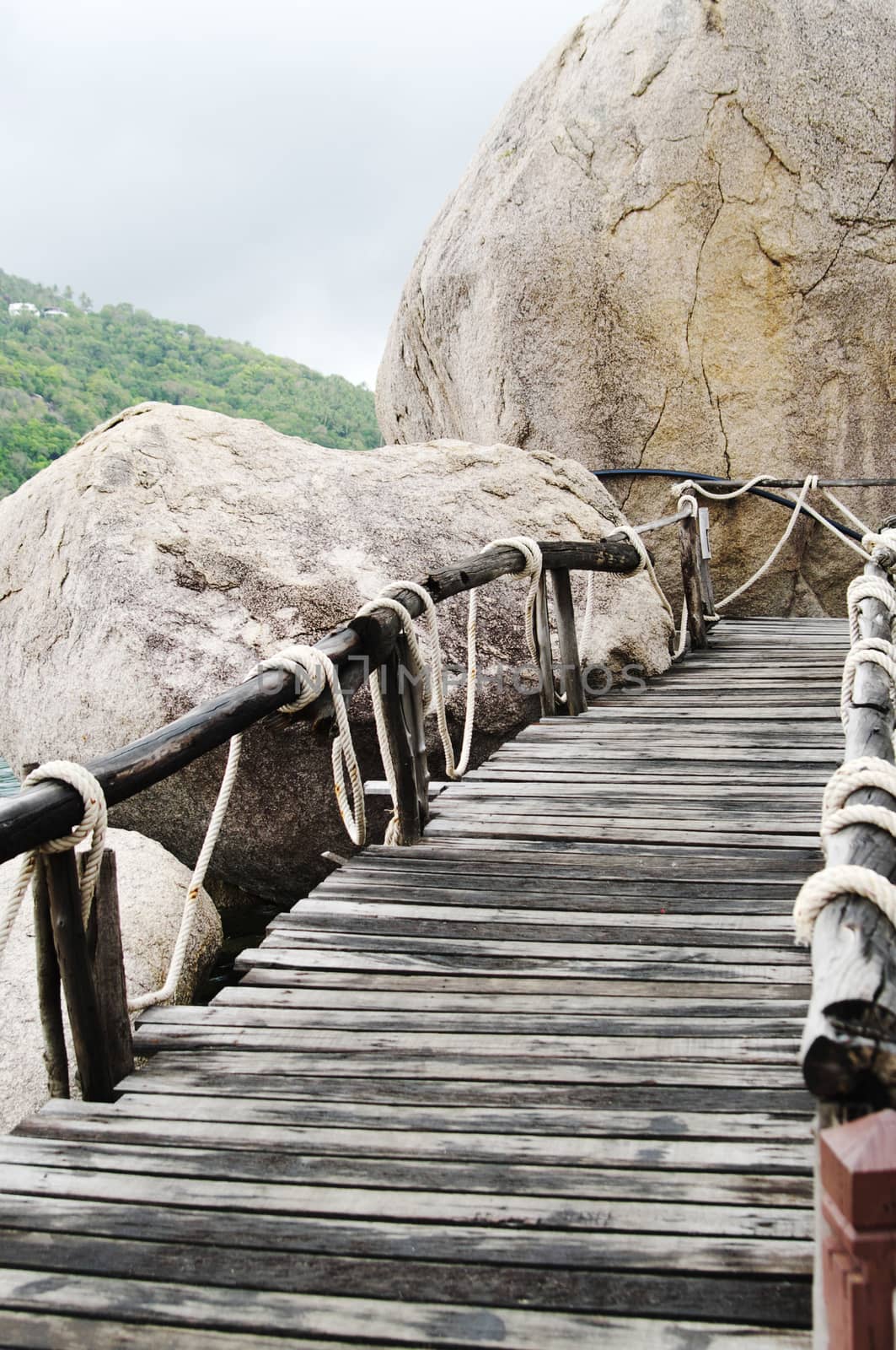 Plank bridge  and huge stones boulders, Koh Nanguan, Thailand by HGalina