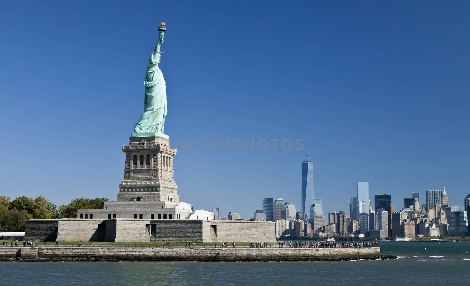 The Statue of Liberty at New York City with the Freedom Tower