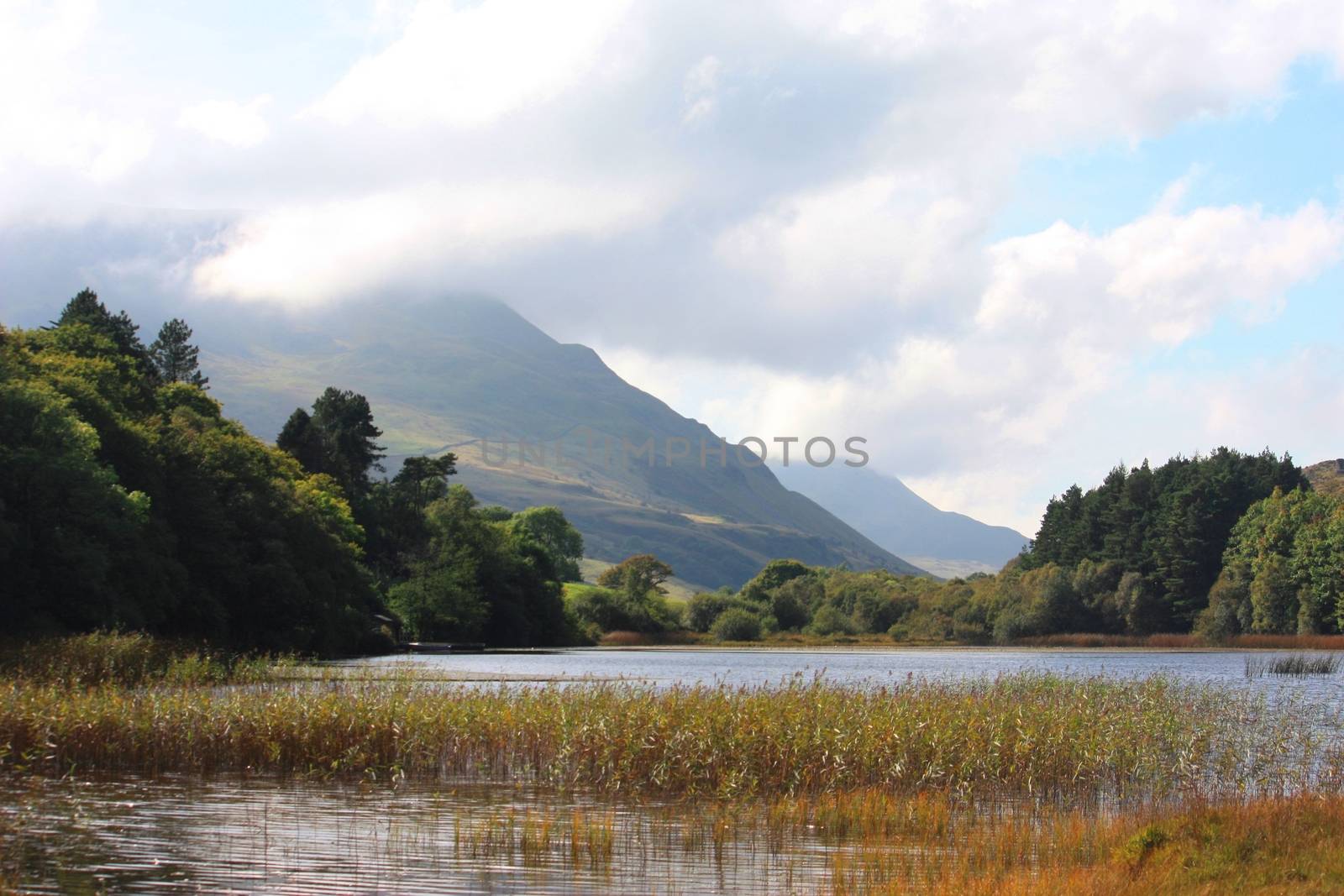 Mountain behind a lake under a moody sky by chrisga