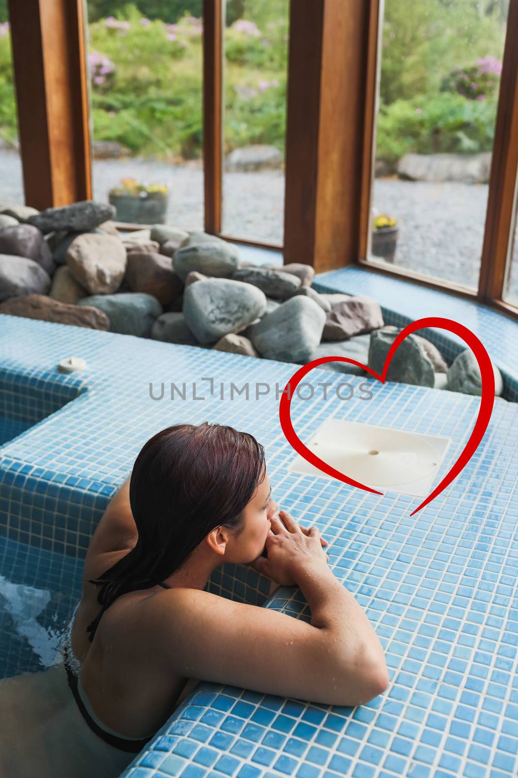 Composite image of brunette relaxing in a jacuzzi by Wavebreakmedia