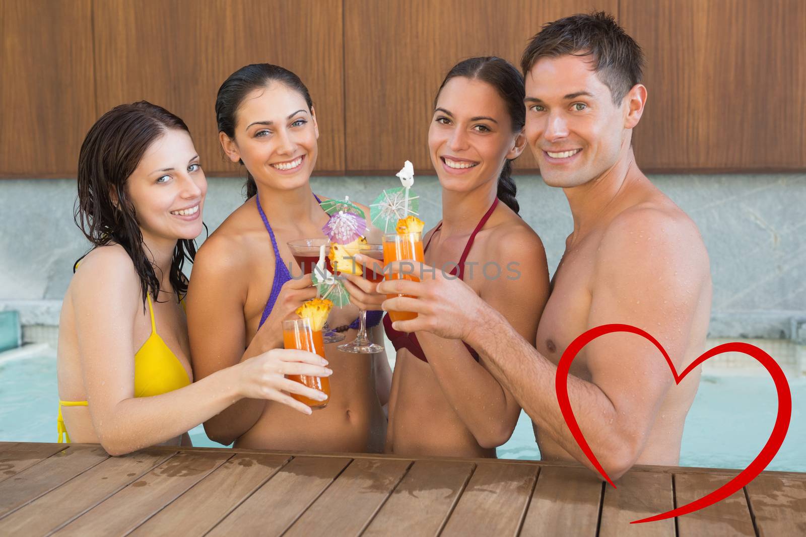 Cheerful people toasting drinks in the swimming pool against heart
