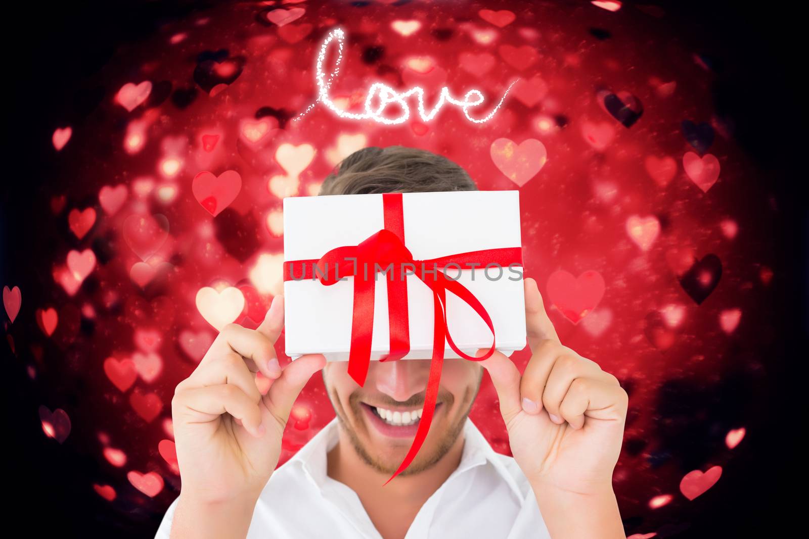 Man holding gift against valentines heart design