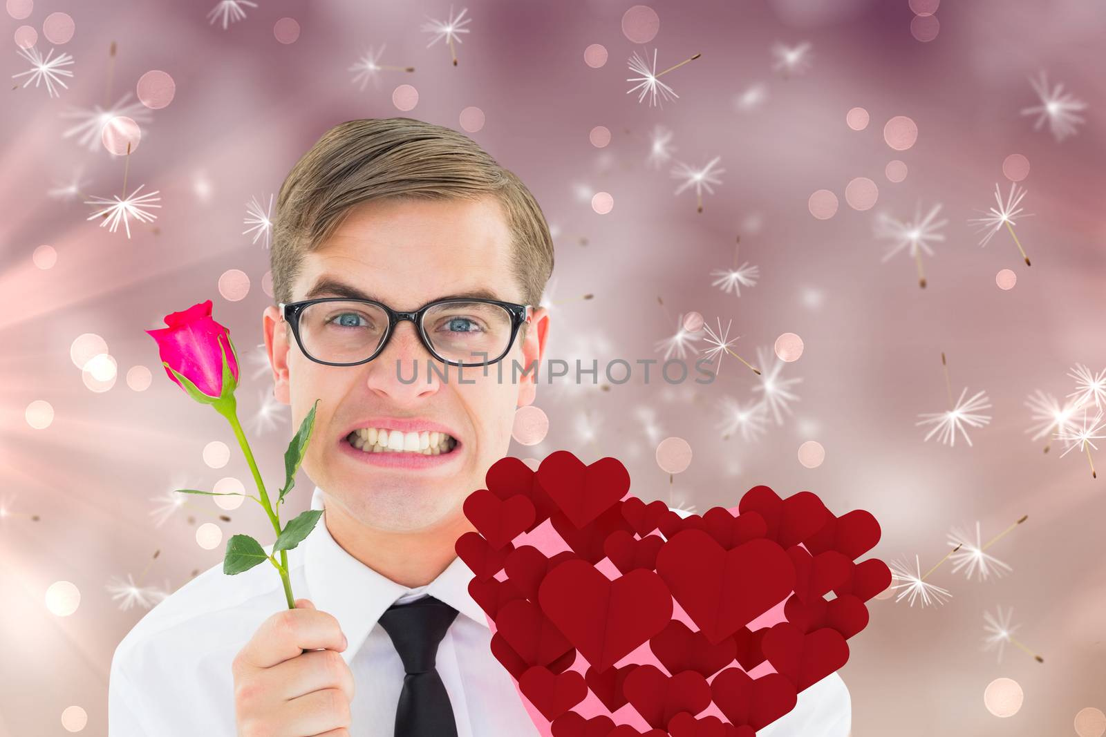 Romantic geeky hipster against digitally generated dandelion seeds on pink background