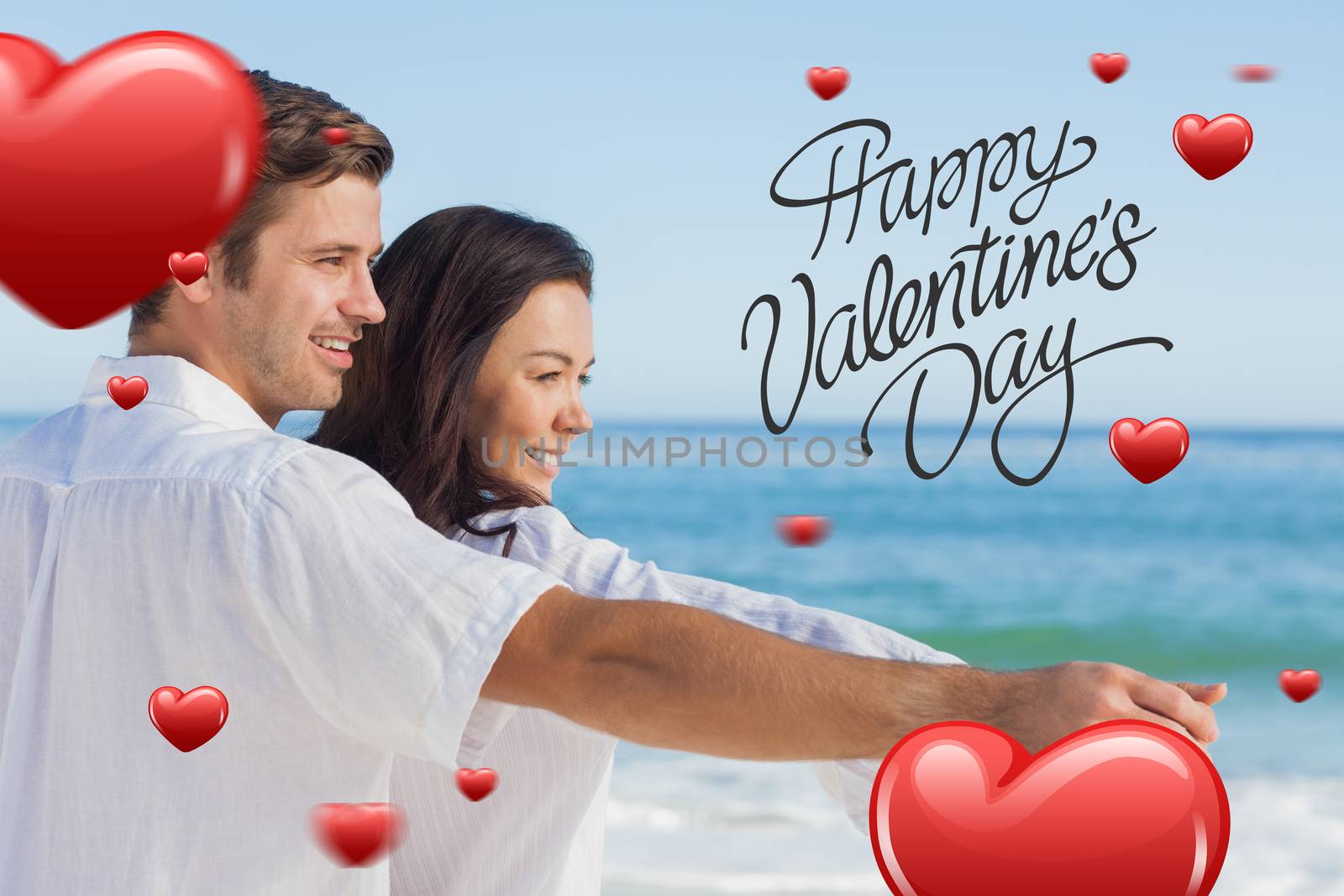 Composite image of romantic couple relaxing on the beach  by Wavebreakmedia