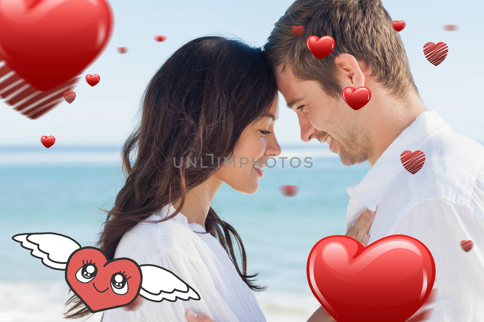Romantic couple relaxing and embracing on the beach  against heart with wings