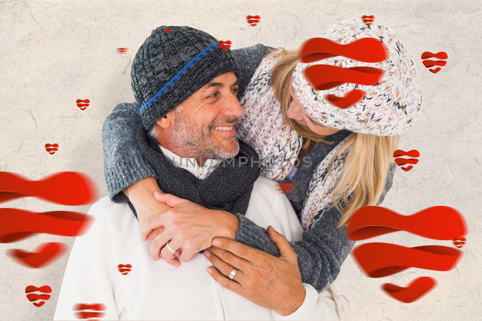 Composite image of happy couple in winter fashion embracing by Wavebreakmedia