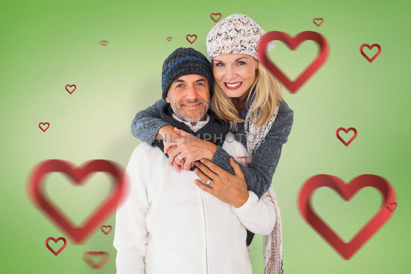 Composite image of happy couple in winter fashion embracing by Wavebreakmedia