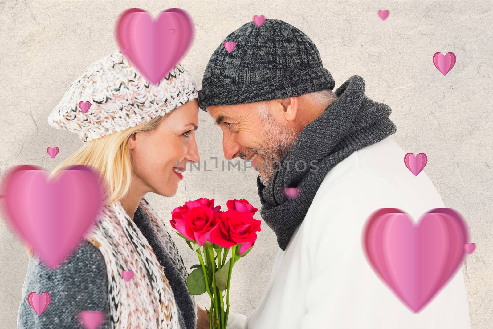Smiling couple in winter fashion posing with roses against parchment