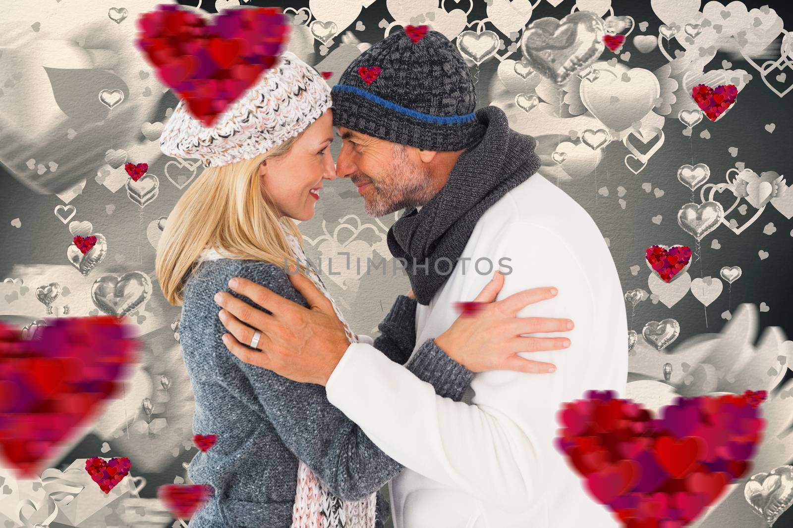 Composite image of happy couple in winter fashion embracing by Wavebreakmedia