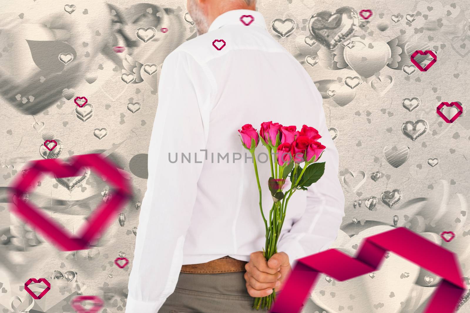 Composite image of man holding bouquet of roses behind back by Wavebreakmedia