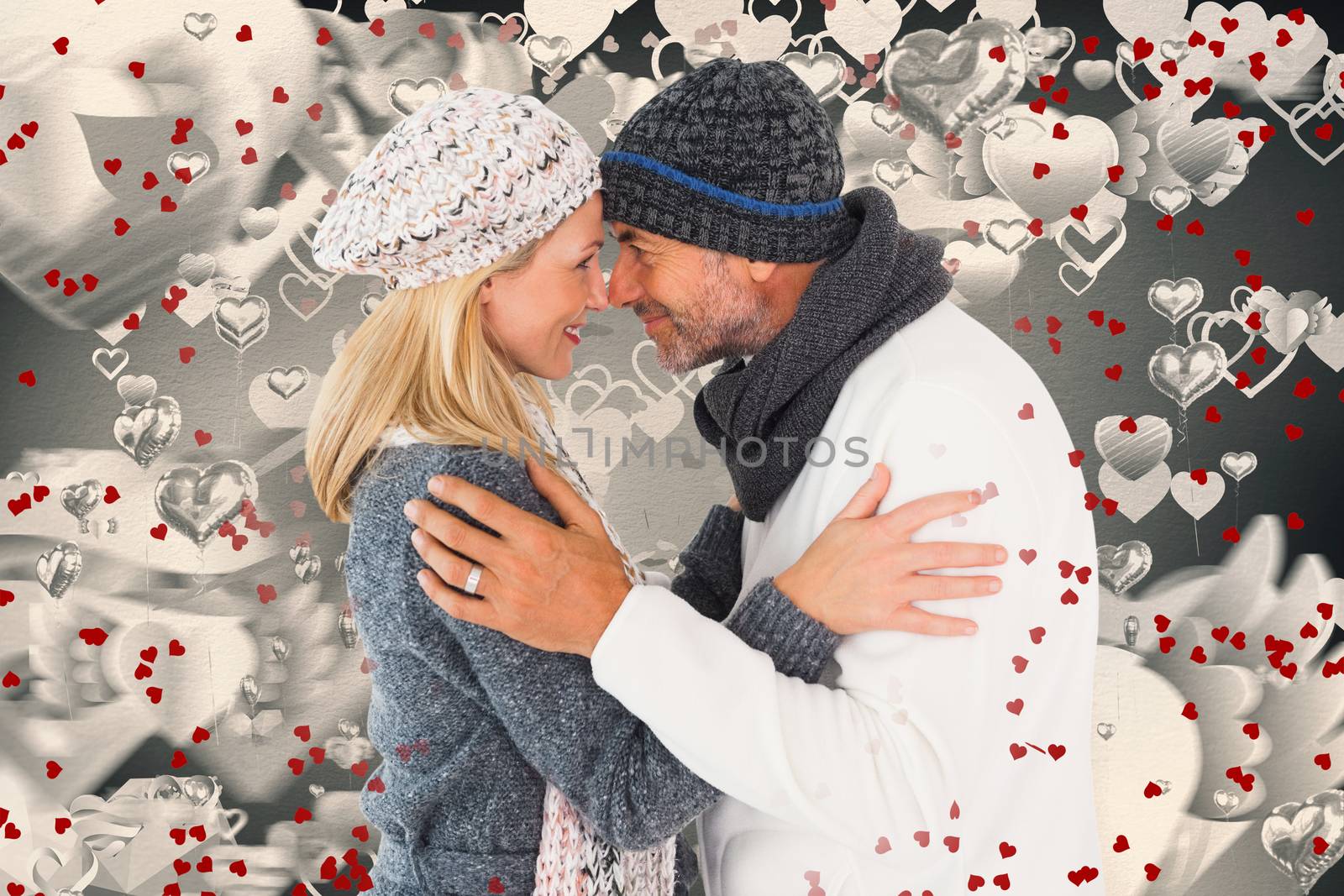 Composite image of happy couple in winter fashion embracing by Wavebreakmedia