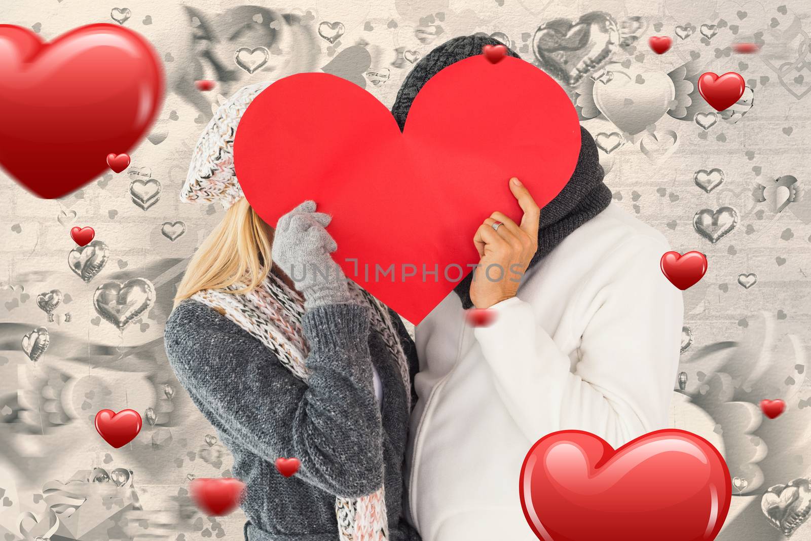 Composite image of couple in winter fashion posing with heart shape by Wavebreakmedia