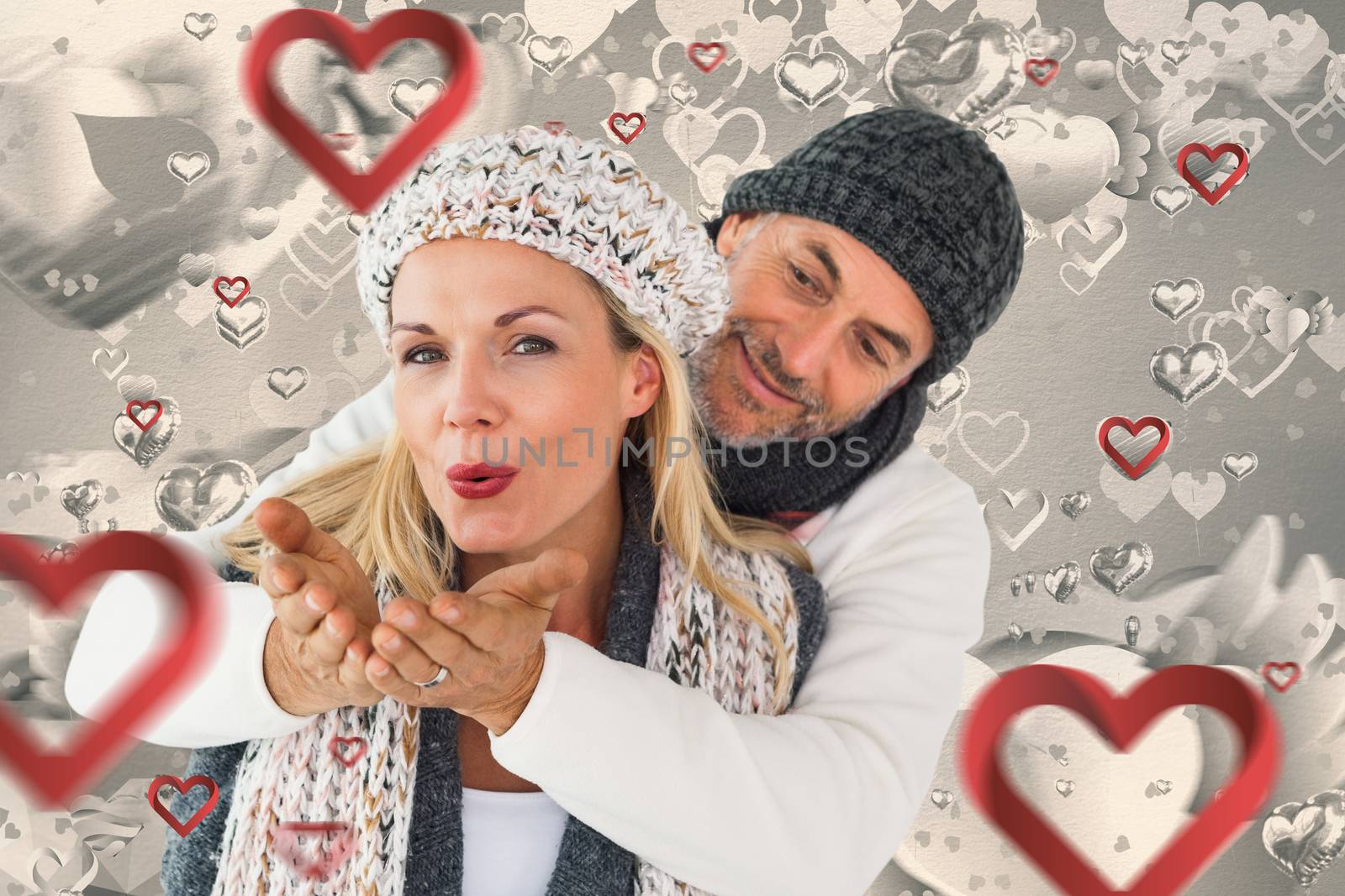 Composite image of smiling couple in winter fashion posing by Wavebreakmedia