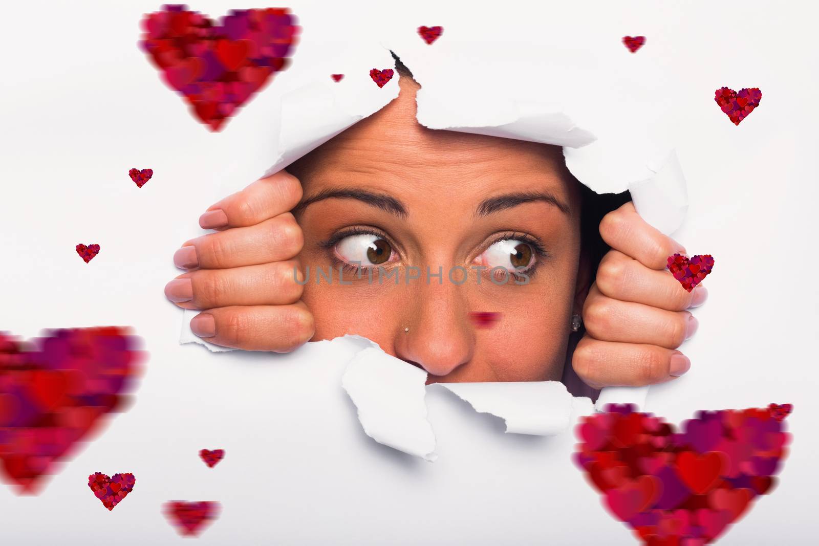 Composite image of young woman looking through paper rip by Wavebreakmedia