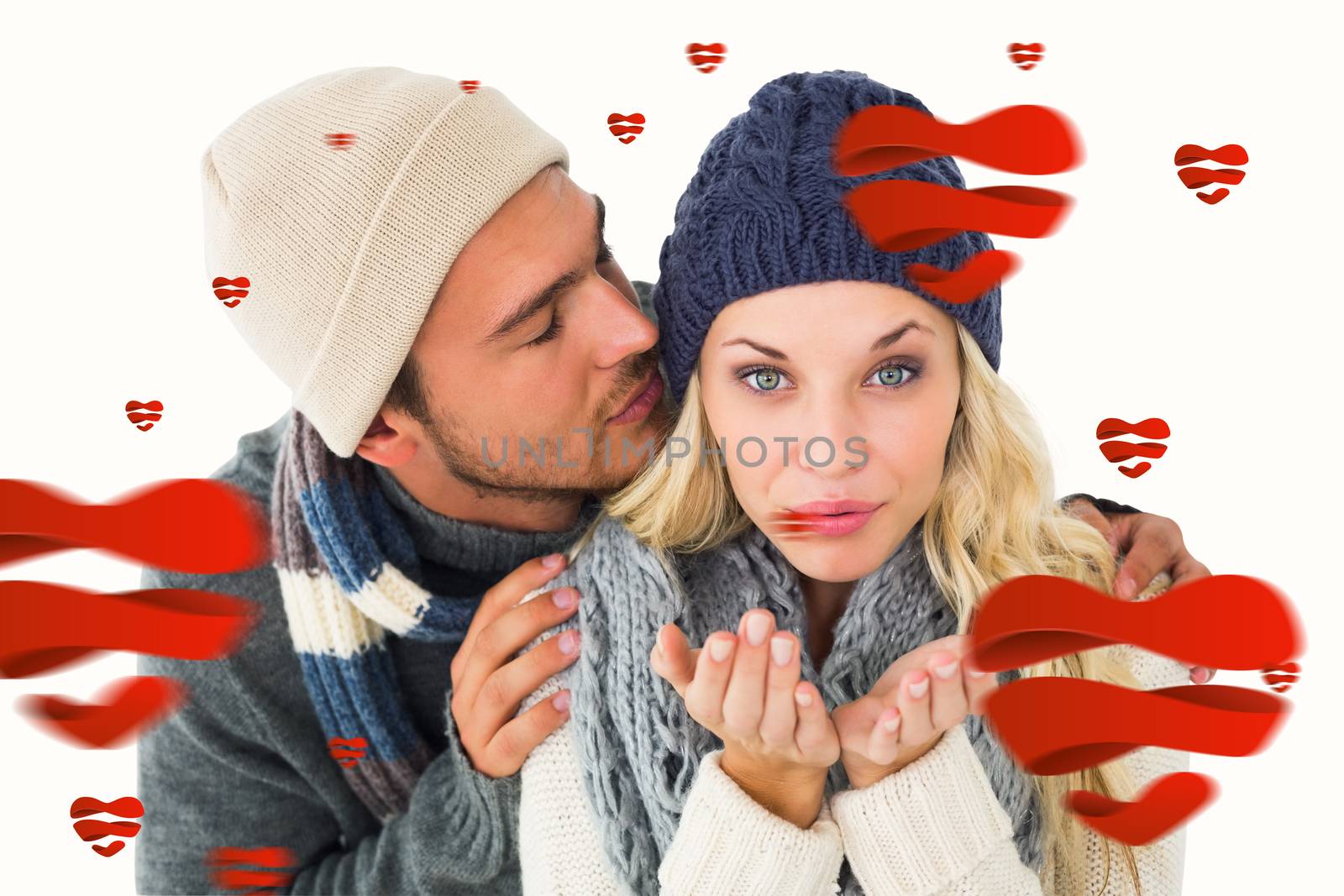 Attractive couple in winter fashion  against hearts