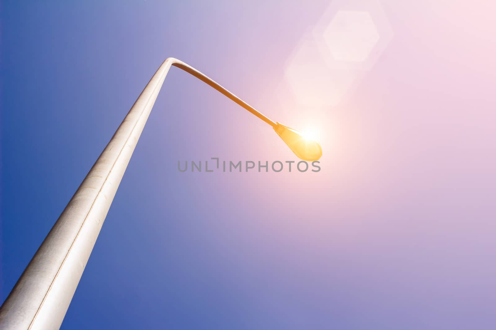 Street light is shining under the sunshine