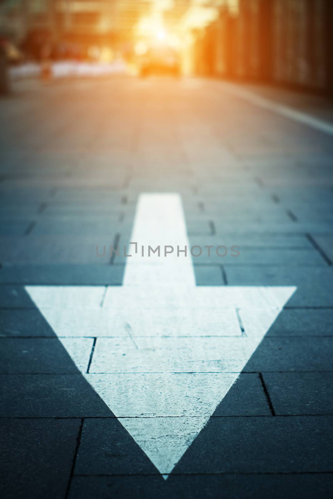 arrow on the road when sunset
