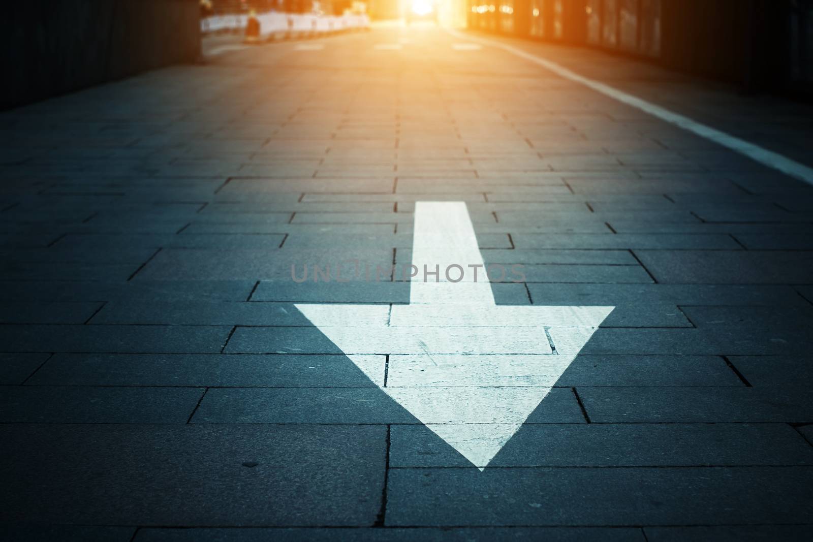 arrow on the road when sunset