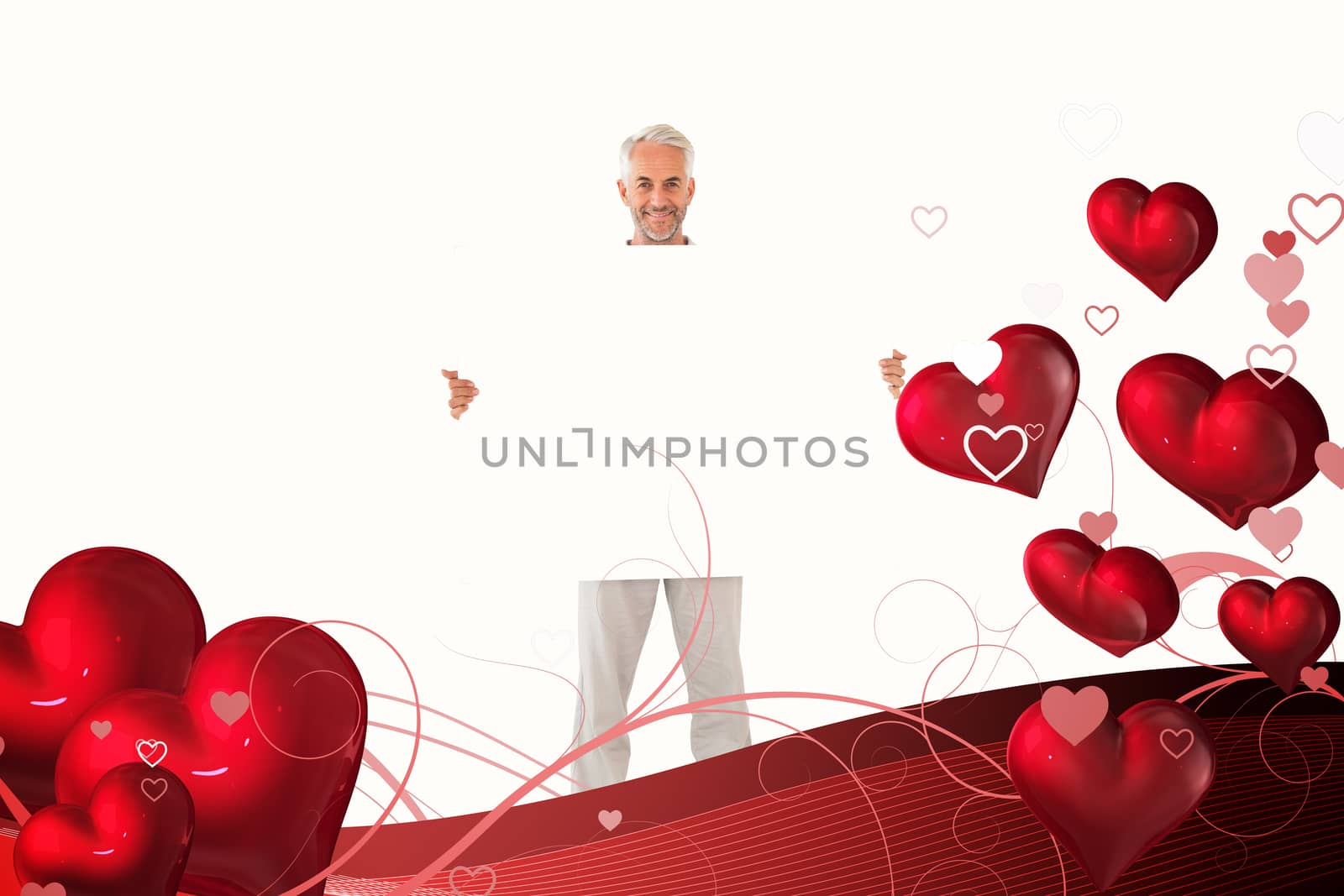 Smiling man showing large poster against valentines heart design