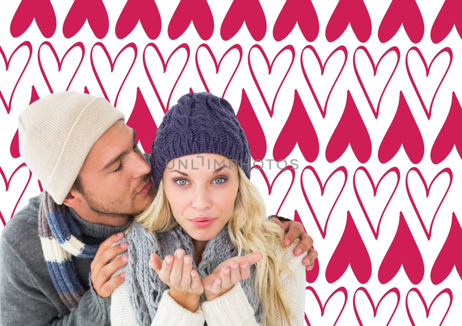 Attractive couple in winter fashion  against valentines day pattern