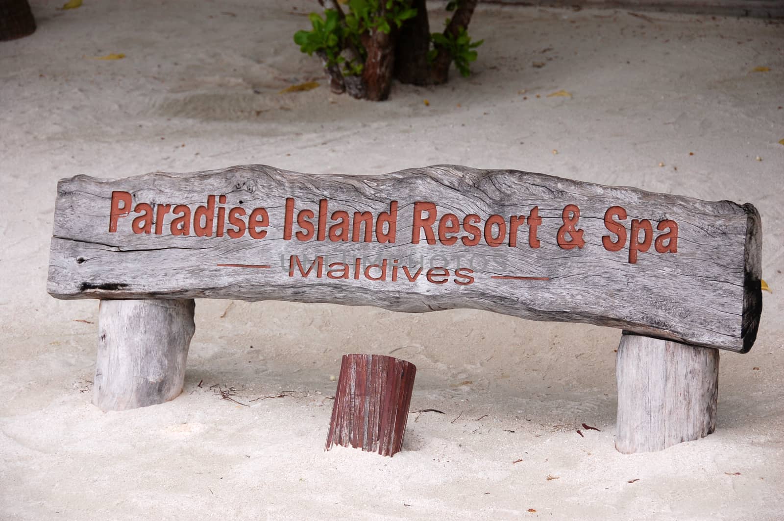 Paradise Island Resort timber name plate at sand beach, Maldives