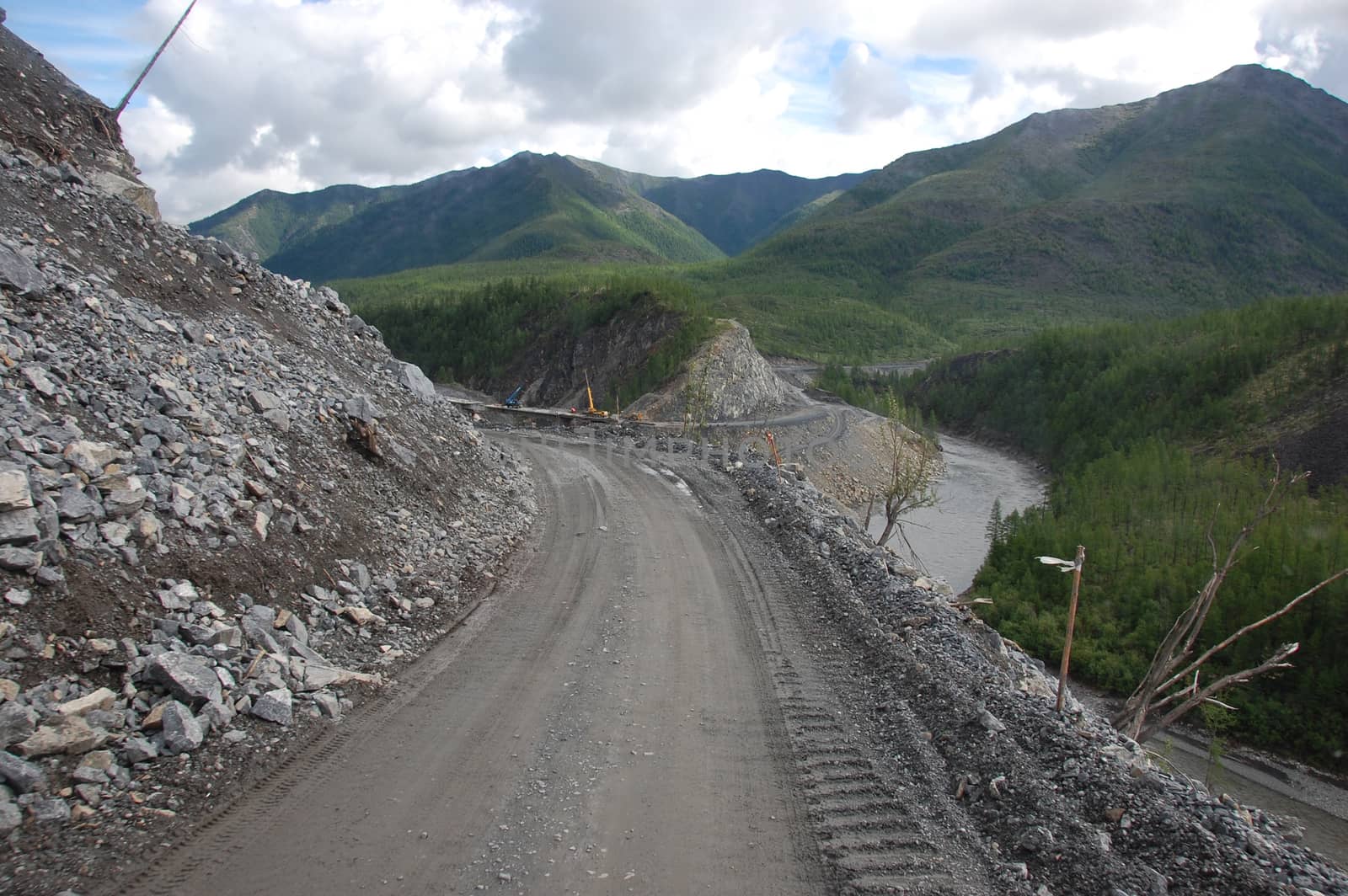 Mountain gravel road turn left, Kolyma state highway, Russia