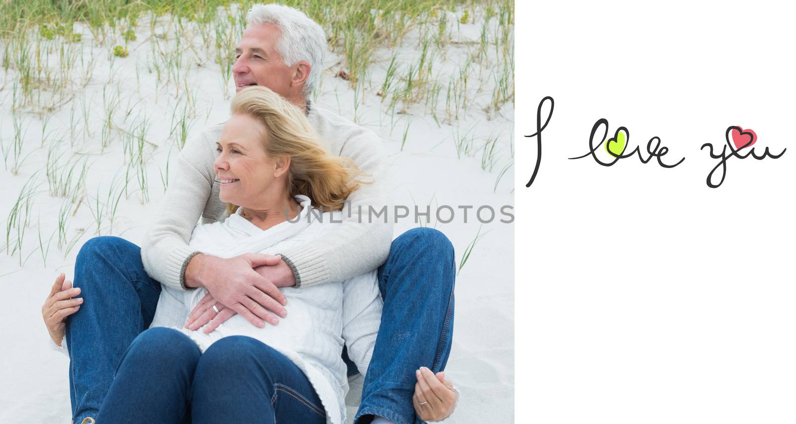 Romantic senior couple relaxing at beach against i love you