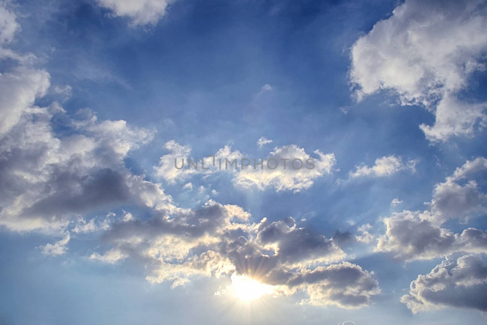 Blue sky with white cloud and sun