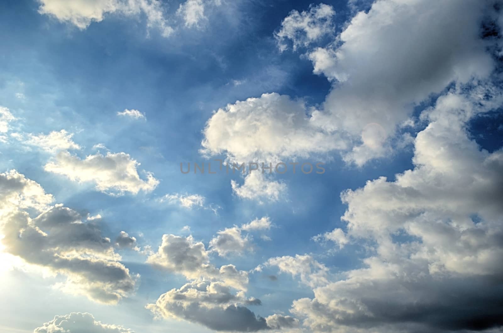 Blue sky with white cloud and sun