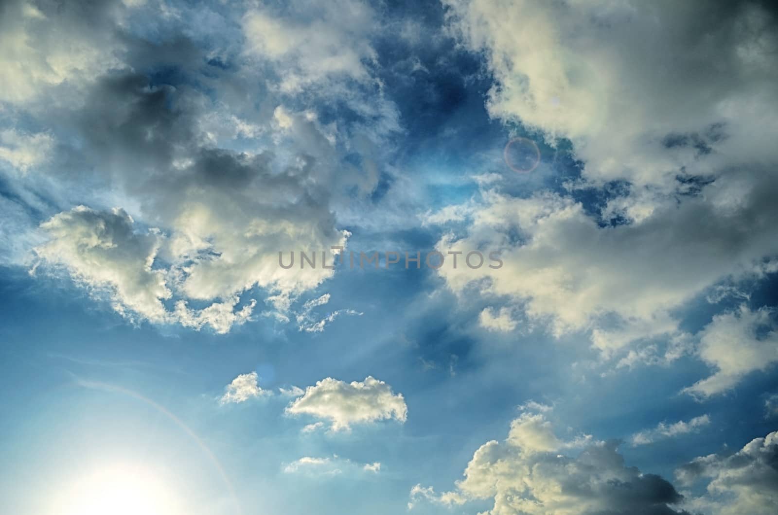 Blue sky with white cloud and sun