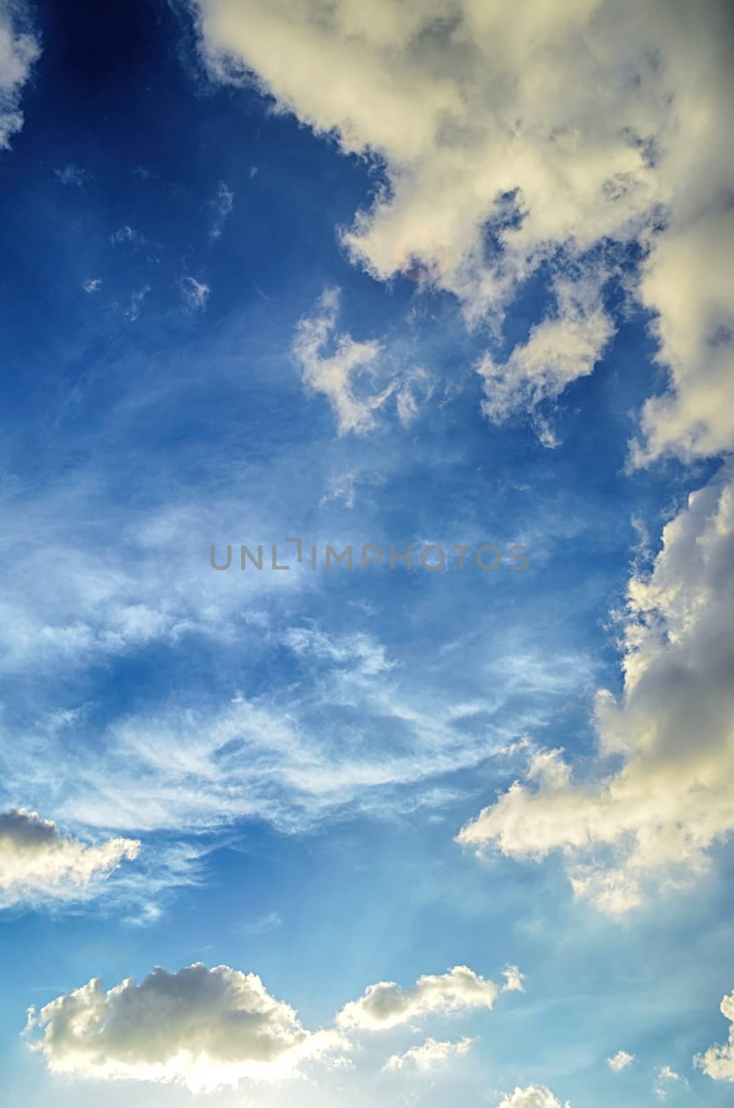 Blue sky with white cloud and sun