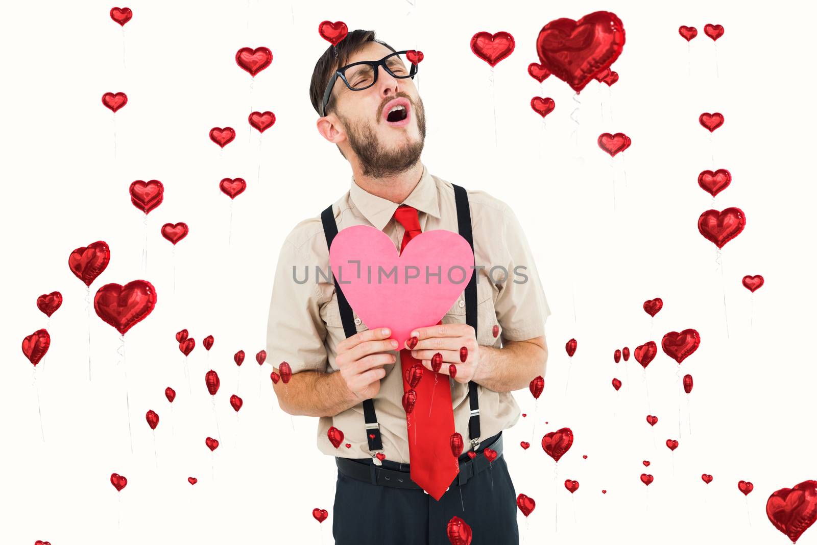 Geeky hipster crying and holding heart card against red heart balloons floating