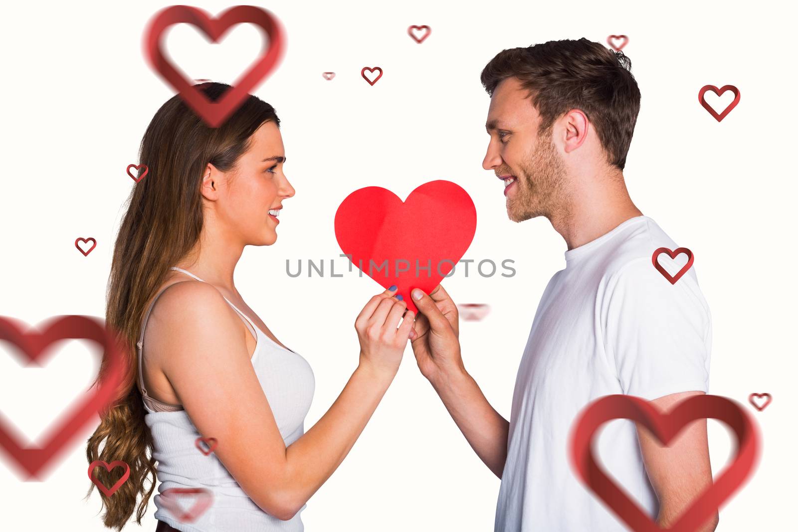 Composite image of romantic young couple holding heart by Wavebreakmedia