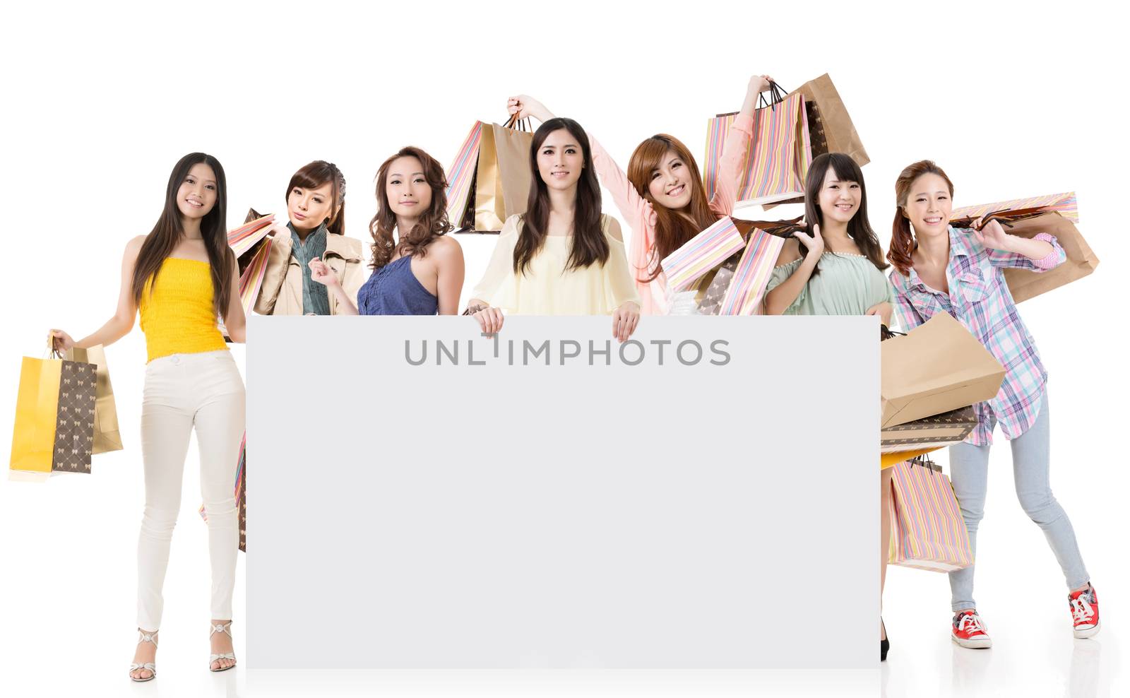 Attractive Asian woman shopping and one lady holding blank board, full length portrait isolated on white background.