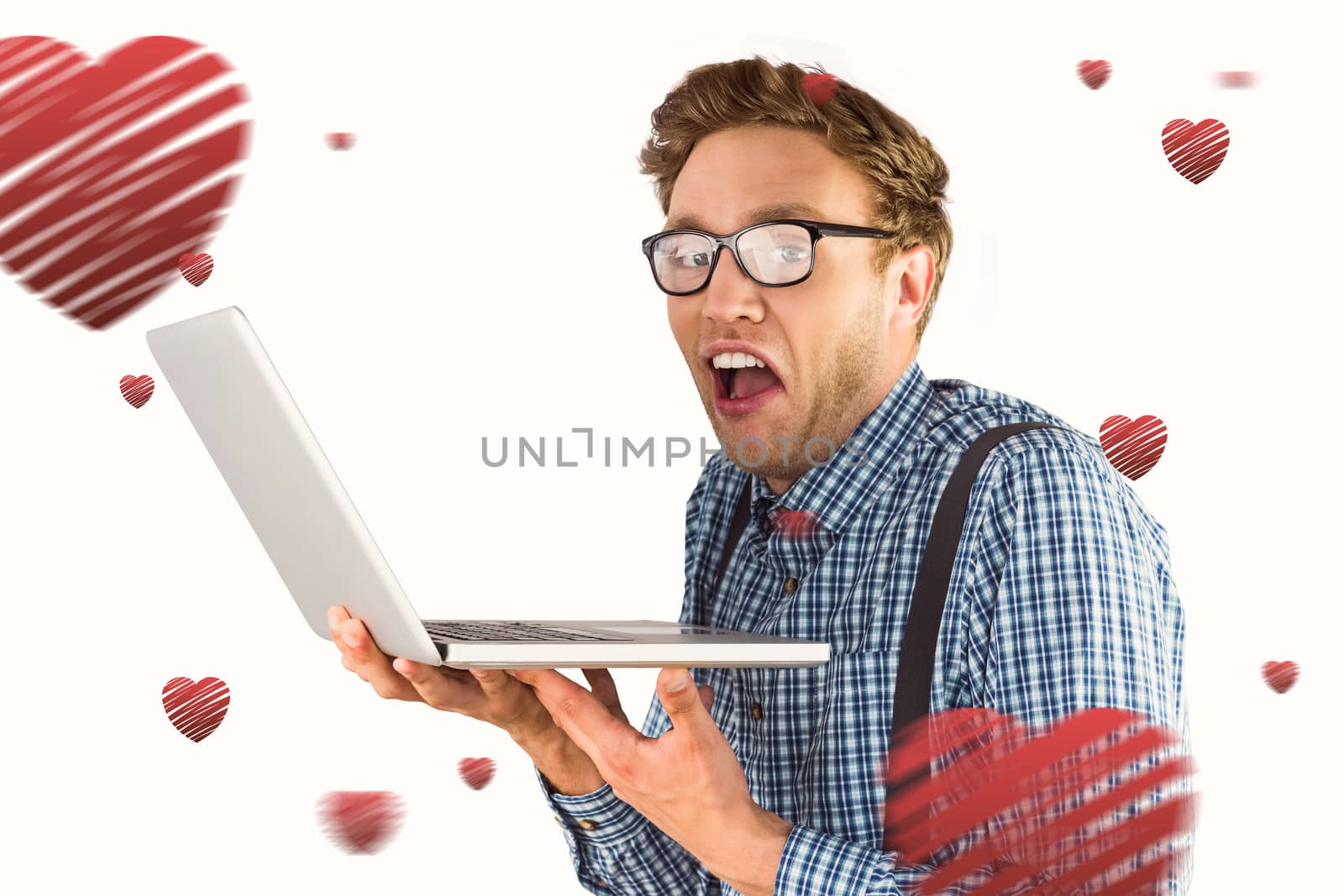 Geeky businessman using his laptop against hearts