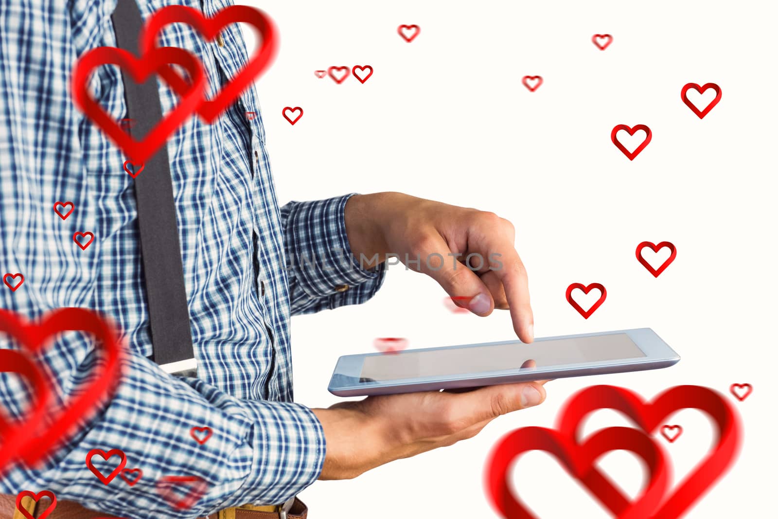 Geeky businessman using his tablet pc against hearts